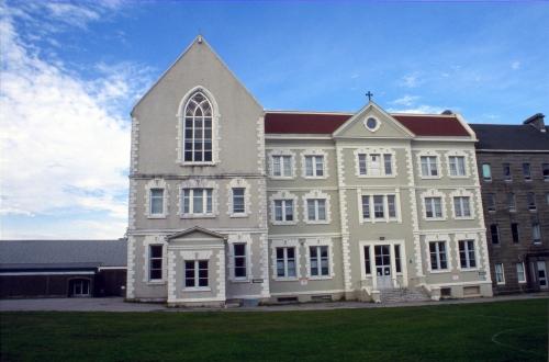 View looking west at main facade of St. Bon's College.  An attached skating rink is on the left of the photo, and the Old College can be seen on the right.  Photo taken about 1999.; HFNL 2007
