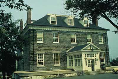 General view of Admiralty House showing as its two-storey rectangular massing, hipped roof with dormers and end chimneys.; Parks Canada Agency / Agence Parcs Canada.
