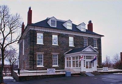 General view of Admiralty House showing symmetrical five-bay facade with pedimented central entry.; Parks Canada Agency / Agence Parcs Canada.