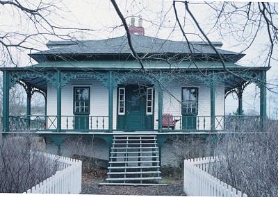 View of entrance showing the Picturesque qualities of the house as a cottage orné, including the square massing under a shallow hipped roof with dormer windows.; Parks Canada Agency / Agence Parcs Canada
