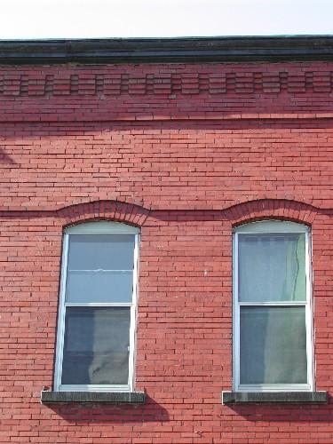 This photograph shows the roof-line cornice and the proportions of the windows that are used throughout the 2nd and 3rd floor, 2004; City of Saint John