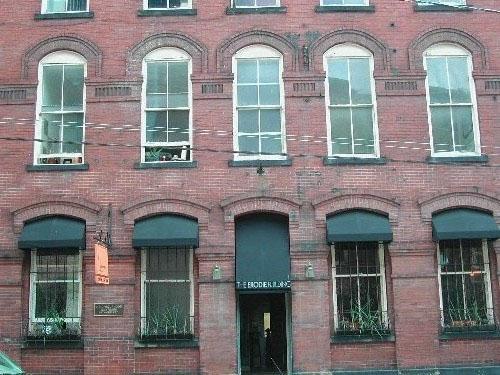 This photograph shows the central entranceway and the awnings that shade the lower floor windows, 2004; City of Saint John