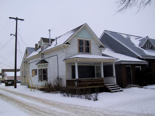 View of the Rehwinkel Parsonage looking toward the northwest corner of the house, with the west facade facing a laneway (January 2005); City of Edmonton, 2005