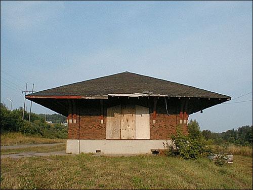 This image presents the one-storey red brick station erected on a concrete foundation.; PNB 2005