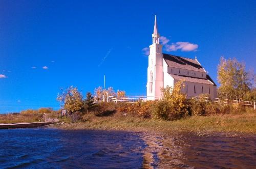Upward view of Church on its prominent "jutting out" point onto the Churchill River.; Government of Saskatchewan, Calvin Fehr, 2004.
