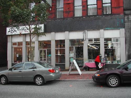 This photograph shows the storefront with the large fascia band and heavy pillars, 2004.; City of Saint John