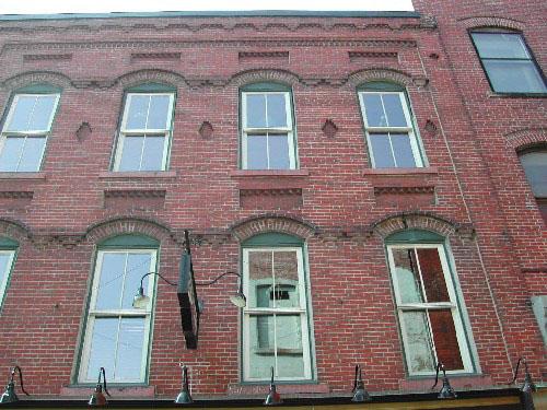 This photograph shows the roofline, window detail, and the decorative brick design, 2004; City of Saint John