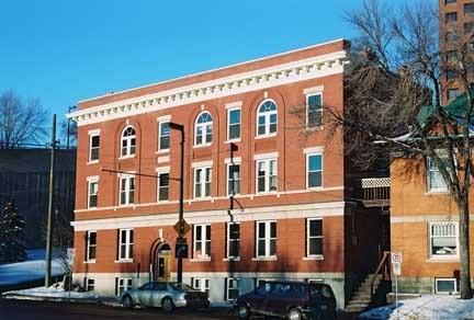 Parkview Apartments - note the typical Edwardian-era and Classical Revival detailing in the series of arched windows, the arched entrance, the large upper cornice and the rectangular brick composition (2004).; City of Edmonton, 2004