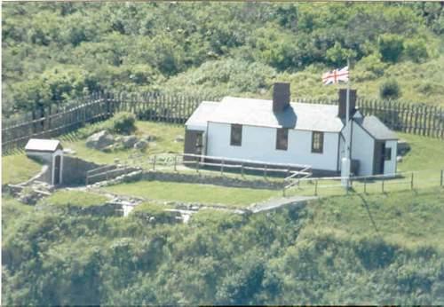 Quidi Vidi Battery barrack with gun deck directly in front of building and powder magazine to the left, 1980.  ; Government of Newfoundland and Labrador