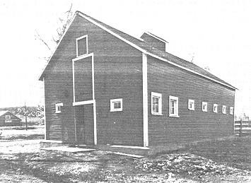General view of the Dairy Barn, showing the front and side façades, 1992.; Department of Public Works, AES, PC, WRO / Ministère des Travaux publics, SAG, PC, BRO, 1992.