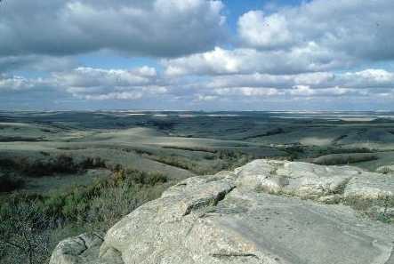 View of the surrounding landscape from the petroglyph outcrop, 1993.; Government of Saskatchewan, 1993.