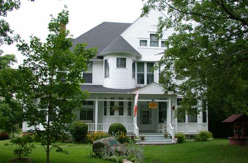 Formal frontal orientation of the house to Maple Street including surrounding grass yard.; PNB 2005