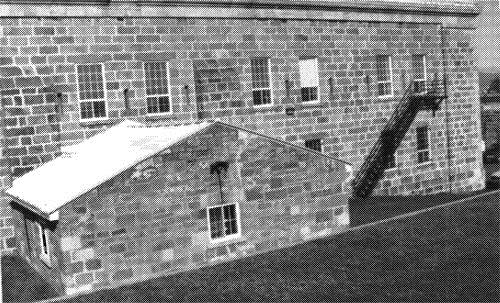 General view of the rear of the Staff Headquarters of the Royal 22 Regiment, former Hospital, Building 1, 1991.; Parks Canada Agency / Agence Parcs Canada, R. Godspeed, 1991.