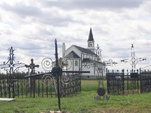 View west at iron cross grave markers and enclosures, 2004.; Government of Saskatchewan, Marvin Thomas, 2004.
