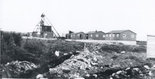 Iron Springs Mine Heritage Site showing the mine buildings and the shaft, also included is the building used as the temporary first aid center for the survivors of the Truxtun and Pollux ship wrecks. Photo ca 1942.; Ena Farrell Edwards 2005.