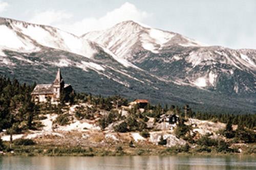 Exterior view of St. Andrew's Presbyterian Church, showing its status as a prominent structure in its surrounding environment, originally as the center of a booming town, now as a landmark in a National Historic Park, 1971.; Parks Canada Agency/Agence Parcs Canada, 1971.