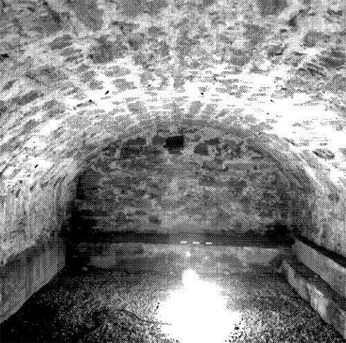 Interior view of the West Front casemates emphasizing the bomb-proof elliptical masonry vault of each unit, 1989.; Parks Canada Agency / Agence Parcs Canada, 1989.