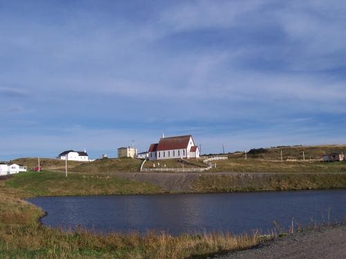 Exterior photo of All Saints Anglican Church and Cemetery, broad view showing general area, English Harbour, NL.  Taken October 2005.; HFNL/ Andrea O'Brien 2005