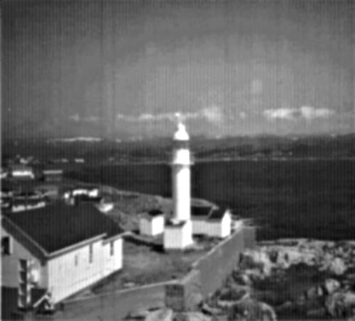 General view of the Channel Head Lighttower, showing the smooth tubular construction and overall utilitarian appearance of the structure in its setting among the only structures on a small island, 1987.; Canadian Coast Guard/Garde côtière canadienne, 1987.