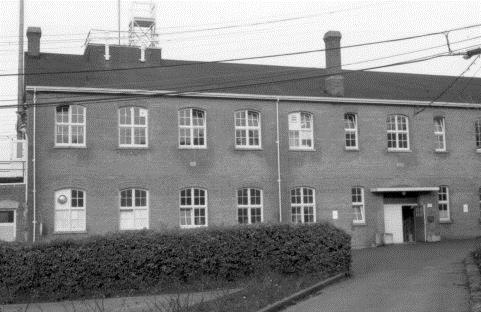 General view of Building D77, Former Ordnance Stores, showing the large, regularly spaced, arched windows, 1970.; (CIHB/IBHC, Parks Canada/Parc Canada, 1970)