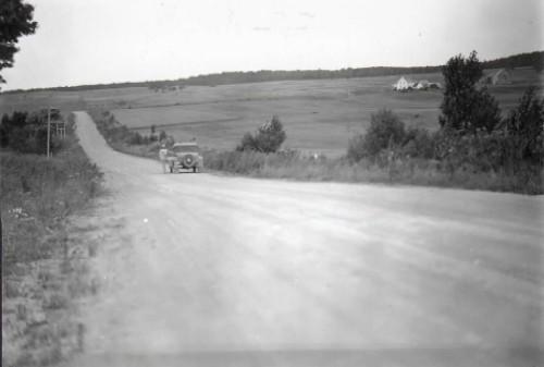 This photo of a car coasting “up” Magnetic Hill appeared in the August 10, 1933 edition of the Telegraph-Journal newspaper in Saint John.  It represents the first widely published report and photos of this phenomenon.; Moncton Museum