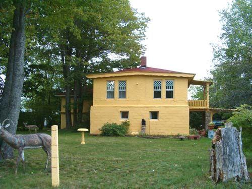 Side elevation showing concrete deer, birth bath and bust; Charles Macdonald House, Centreville, NS, 2005.; Heritage Division, NS Dept. of Tourism, Culture and Heritage, 2005.