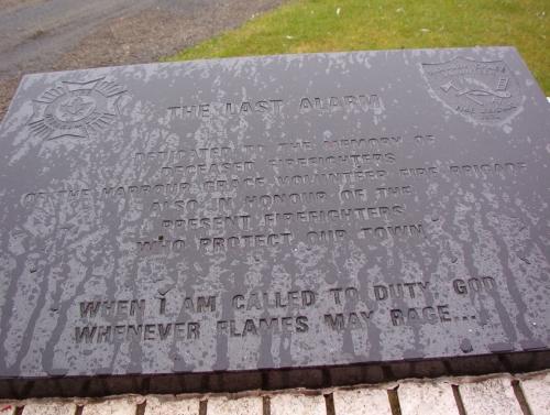 Exterior photo of the memorial plaque situated directly below the Harbour Grace Fire Bell, Water Street, NL.  ; HFNL/ Deborah O'Rielly 2005