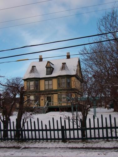 Exterior view of The Maples, Harbour Grace.  View shows house set back and portion of fence.; HFNL 2005