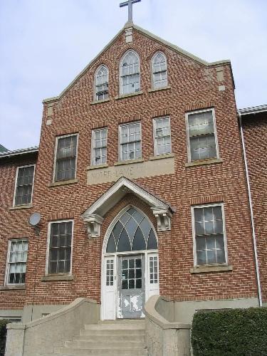 Close-up of front façade, highlighting gothic-arched windows and cross, 2004.; Government of Saskatchewan, Jennifer Bisson, 2004.