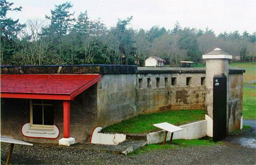 General view of the Guardhouse showing its position next to the gate and the loopholed bulge in the defensible wall, 1997.; Parks Canada Agency / Agence Parcs Canada, J. Mattie, 1997.