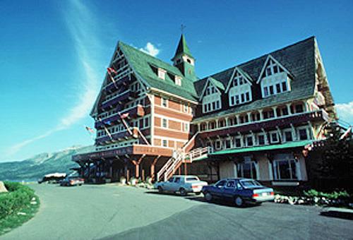 Corner view of the Prince of Wales Hotel National Historic Site of Canada showing its blocky, six-storey massing and its reliance on wood materials for its construction, cladding and detailing, 1989.; Parks Canada Agency / Agence Parcs Canada, W. Lynch, 1989.