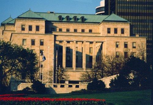 Side view of the West Memorial Building showing the streamlined low-pitched battened copper roof with dormer windows and tall corner tower with pavilion roof, 1991.; Parks Canada Agency / Agence Parcs Canada, E. Tumak, 1991.