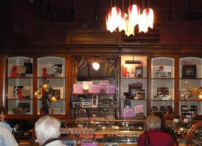 Interior view of Rogers Building, showing original surviving interior fixtures and decorative detailing, including glass-fronted cabinets and curve-topped glass counters, 2011.; Parks Canada Agency / Agence Parcs Canada, Andrew Waldron, 2011.