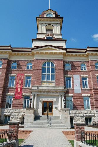 General view of St. Boniface City Hall, showing its red brick exterior facing materials contrasted with rusticated masonry basement and  buff limestone trim, 2010.; St. Boniface City Hall, AdolfGalland, May 2010.
