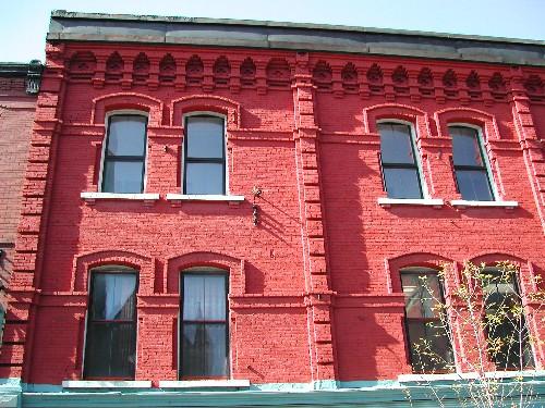 This photo shows the pilasters that separate the bays and the continuous line of projecting brick. 2004; City of Saint John
