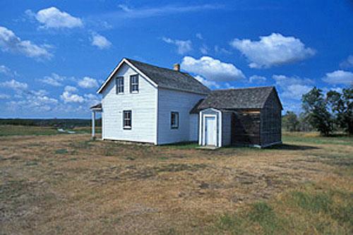 General view of the rear of the Former Jean Caron Sr. House showing the simple, rectangular form and one-and-a-half storey massing of the functional structure, 2003.; Parks Canada Agency / Agence Parcs Canada, D. Venne, 2003.