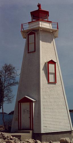 View of the entrance of the Light Tower, showing the gable hoods over the windows with minimal fascias and the simple detailing, 1990.; Department of Transport / Ministère des Transports, 1990.