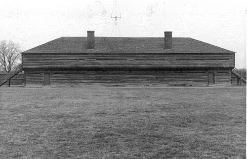 View of the façade, showing the exterior walls composed of squared logs with dovetailed corners, circa 1989.; Parks Canada Agency / Agence Parcs Canada, circa 1989.