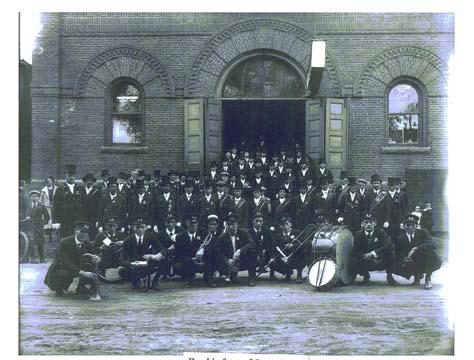 Group photo of Orange Lodge members and band in front of Orange Hall (Opera House), 1904.; PANB, P6-294
