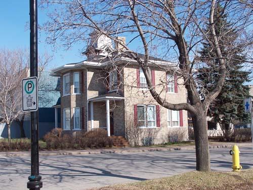 This angle view of the south façade of the Albert House reveals a portion of the front porch.; Town of Edmunston