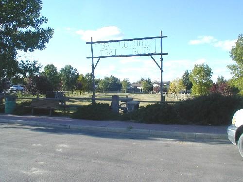 View of the property, including gate sign, cairn and plaque, 2004.; Dan Knutson, 2004.