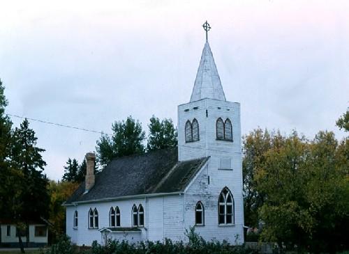 View of front and north elevations, showing central spire and symmetrical Gothic-arched windows, 1987.; Government of Saskatchewan, Frank Korvemaker, 1987.