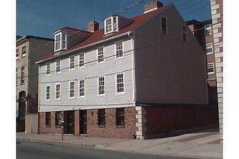 Alex McLean House, follows slope, steeply pitched gable roof, quoins on brick first storey, entrance immediately fronts sidewalk, Halifax, Nova Scotia, 1997.; HRM Planning and Development Services, Heritage Property Program, 1997.