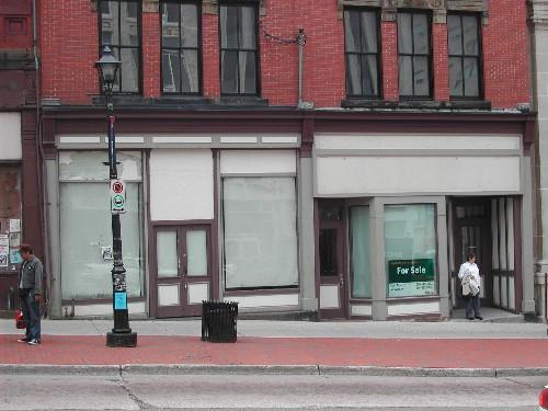 This photograph shows the three entrance storefront, columns and storefront cornice, 2004; City of Saint John