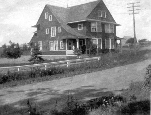 Dr. Paisley sits on his front porch; Mount Allison University Archives, 005 108