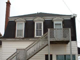 Original trim and dormer detail on mansard roof of the Kent Northern Hotel building.; Village of Rexton