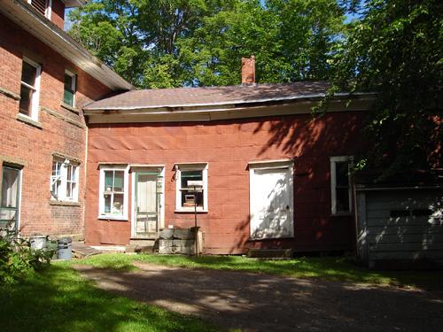 Image taken from the rear of 814 Main Street, showing ell and other attached outbuildings.; Carleton County Historical Society