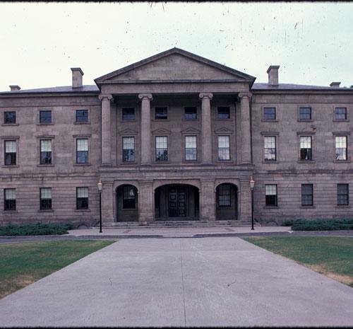 General view showing the symmetrical three-storey massing of the building with its central section, balanced wings and shallow hipped roof.; Parks Canada Agency / Agence Parcs Canada