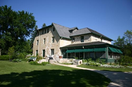 View from the northeast of the gardens and secondary elevations of the Captain William Kennedy House, Lockport area, 2005; Historic Resources Branch, Manitoba Culture, Heritage, Tourism and Sport, 2005