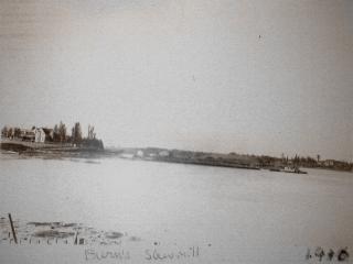 Burns Mill with a large sawdust pile and boat.; Village of Rexton